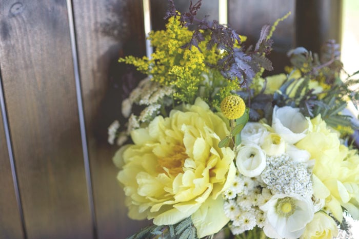 yellow yearrow, white anemone, white ranunculus and feverfew bridal bouquet for a montana wedding