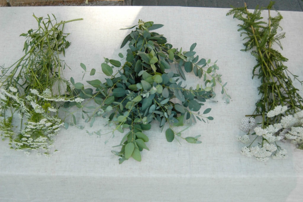 queen anne's lace, yarrow, and eucalyptus on a table 