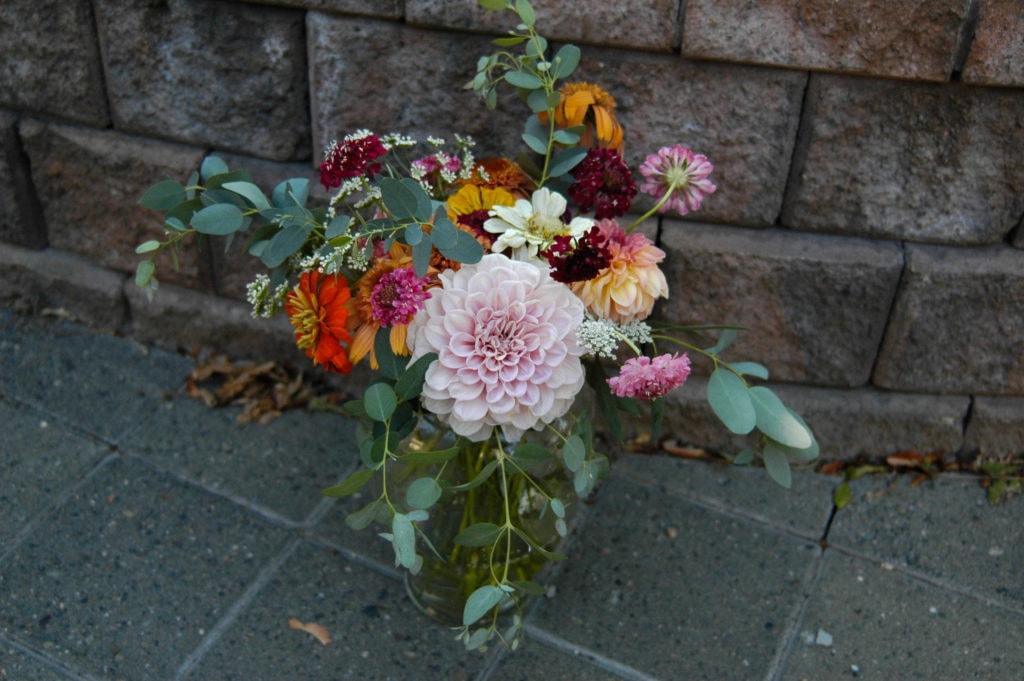 assorted flowers in vase that are seasonal to August