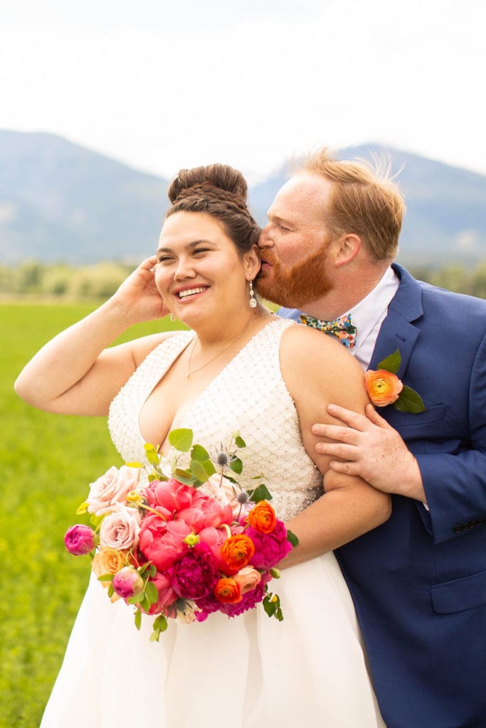 bride and groom in front of mountains