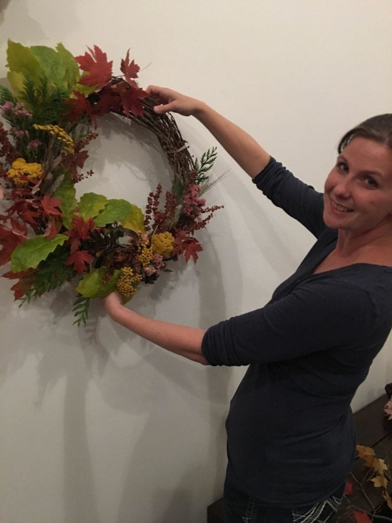 workshop attendee holding wreath