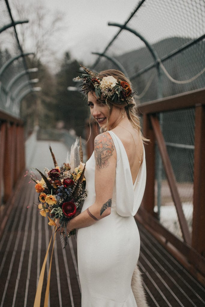 Bride holding bouquet and wearing flower crown designed by Missoula florist